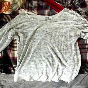 grey long sleeve top, hangs off the shoulder a bit
